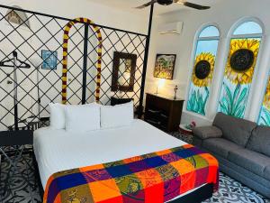a bedroom with a bed and a couch at The Quetzal in Cancún