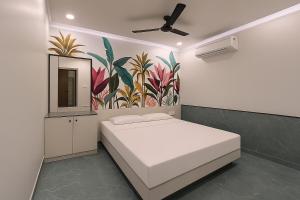 a bedroom with a bed and a painting on the wall at Hotel Aasi inn in Nagpur +6 photos