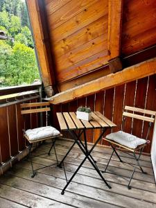 a table and two chairs sitting on a porch at Da Zenz in Paluzza +5 photos
