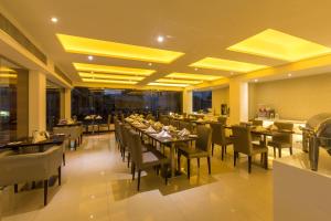 a dining room with tables and chairs in a restaurant at Best Western Elyon Colombo in Colombo