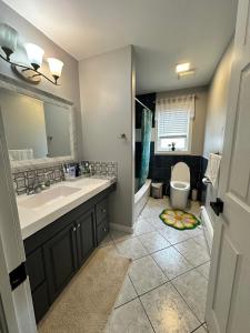 a bathroom with a sink and a toilet at 3-Bedroom Modern House in Halifax +36 photos