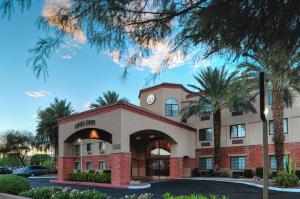 a hotel building with a palm tree in front of it at Hilton Vacation Club Varsity Club Tucson in Tucson