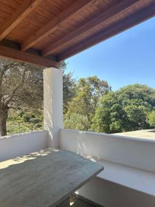 a balcony with a table and a view of trees at Mina's Kypri Apartment in Kipri