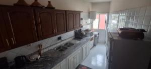 a kitchen with a sink and a refrigerator at Residence Imane in Mohammedia