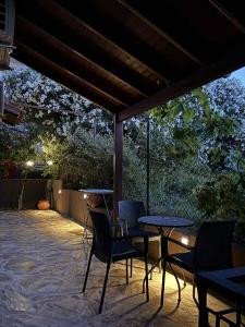 a patio with a table and chairs on a patio at Lyria Hotel Apartments in Stalos