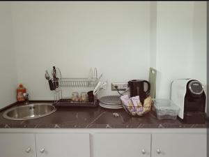 a kitchen counter top with a sink and a counter top at Room private Ossi in Ossi