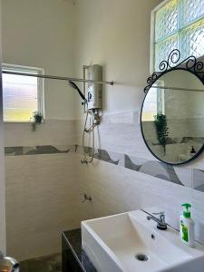 a bathroom with a sink and a mirror at Spacious homestay seremban in Seremban +19 photos