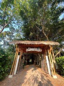 a wooden gate with a sign that says chagra at El Campito Lodge in Ayampe