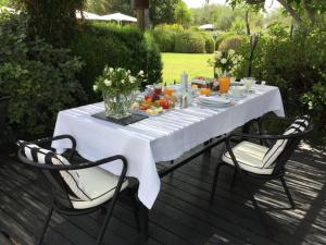 a table with a white table cloth on it with two chairs at Quinta da Lua in Tavira
