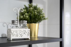 two glass bottles on a table with a potted plant at GuestReady - Lovely home with river view in Bandeira +34 photos