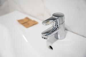 a bathroom sink with a chrome bathroom faucet at GuestReady - Lovely home with river view in Bandeira
