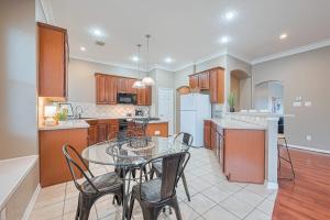 a kitchen with a glass table and chairs in it at Peaceful Exec Home w Office Near Everything in Conroe