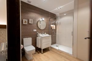 a bathroom with a toilet and a sink and a shower at La casa del huerto in Caravaca de la Cruz +96 photos