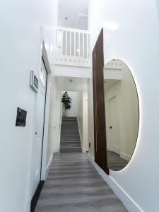 a hallway with a mirror and a stairway at Casa Madrisqui in Homestead
