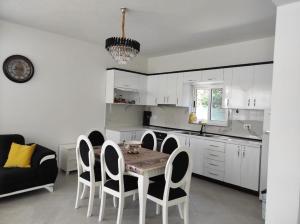 a kitchen with a table and chairs in a room at Residence Mary in Velipojë
