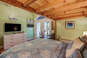 a bedroom with a bed and a tv and a table at Poolside Relaxation Resort Condo in Naples! in Naples