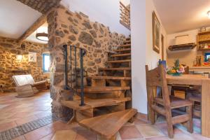 a wooden staircase in a room with a stone wall at Villa Marevic in Vrh