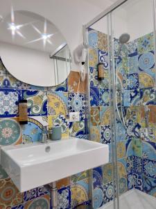 a bathroom with a sink and a mirror at Fata Morgana Guest Rooms in Diamante