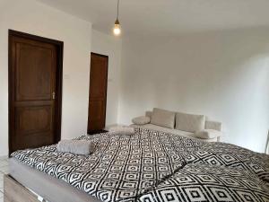 a bedroom with a large bed and a couch at Dózsa Vendégház in Balatonboglár +39 photos
