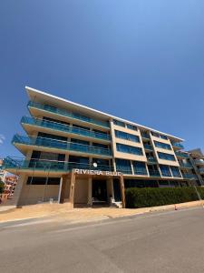 a large building with a sign in front of it at Riviera Blue Hotel in Sunny Beach