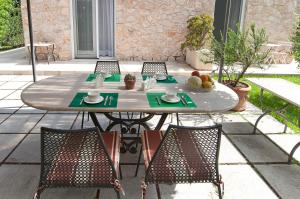 a table and chairs sitting on a patio at Stelle Galeotte Exclusive Holiday Home in Fondi