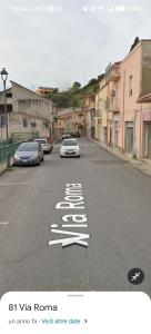 a car is driving down a street with a sign that says slow at Room private Ossi in Ossi
