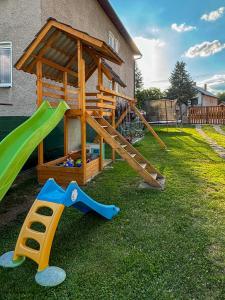 a playground with a slide and a play structure at ViVi Apartments in Liptovský Mikuláš