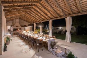 a long tables and chairs under a wooden ceiling at Tranquil Istria Estate Palazio Clai Winery 8 Bedrooms Spa & Heated Pool in Grožnjan