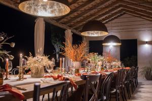 a long table in a room with chairs and lights at Tranquil Istria Estate Palazio Clai Winery 8 Bedrooms Spa & Heated Pool in Grožnjan +32 photos