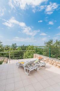 a patio with a table and a bench on a patio at Apartments in Klimno - Insel Krk 13574 in Klimno