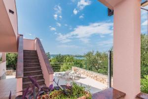 a view from the balcony of a house with stairs at Apartments in Klimno - Insel Krk 13574 in Klimno