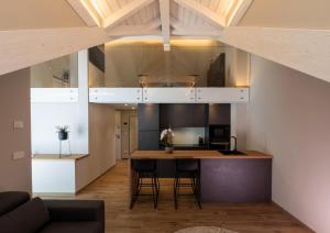 a kitchen and living room with a table and chairs at Ariel Penthouse - In the heart of Domodossola in Domodossola