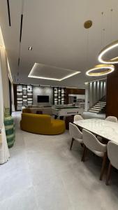 a living room with a yellow couch and tables at Villa Talya in Marrakech