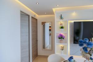 a living room with a television and flowers on shelves at Luxury apartment with sea view in Cartagena de Indias +39 photos