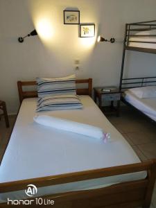 a bed in a room with two bunk beds at Avra Ηouse in Kriopigi