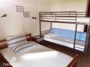 two bunk beds in a small room with a window at Avra Ηouse in Kriopigi