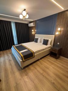 a bedroom with a large bed with a blue wall at The Pearl Airport Hotel in Arnavutköy +46 photos