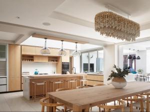 a large kitchen with a wooden table and chairs at Secret Sands in Wilderness