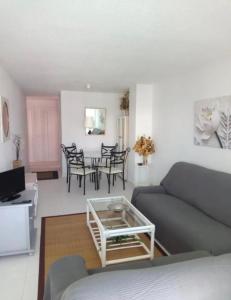 a living room with a couch and a table at Apartamento en el Puerto Deportivo in Alcossebre