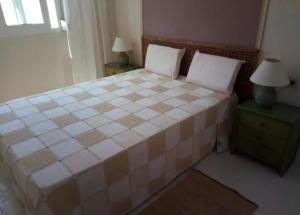 a bedroom with a large bed with two night stands at Apartamento en el Puerto Deportivo in Alcossebre