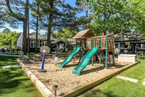 a playground with a slide in a yard at The Cozy Shore Cottage - Standard Single in Wasaga Beach