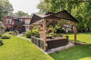 a pavilion with a garden in a yard at The Cozy Shore Cottage - Standard Single in Wasaga Beach