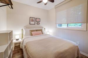 a white bedroom with a bed and a window at The Cozy Shore Cottage - Standard Single in Wasaga Beach