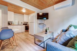 a living room with a couch and a table at The Cozy Shore Cottage - Standard Single in Wasaga Beach +43 photos