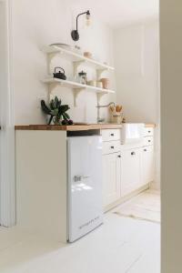 a kitchen with white cabinets and a counter at The Wild Rose - Cozy PEC Rental in Picton in Picton +23 photos