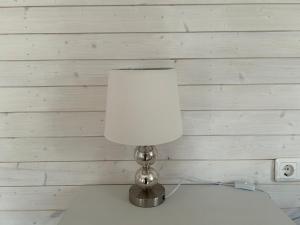 a lamp sitting on top of a table in a room at Namelis Drevernoje in Dreverna