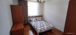 a bedroom with a bed and a window at 2 rooms Condo near Zoom Beach in Constanţa