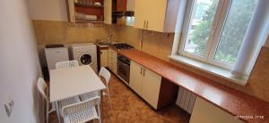 a small kitchen with a table and a sink at 2 rooms Condo near Zoom Beach in Constanţa +14 photos