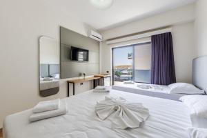 a hotel room with two beds and a large window at Hotel Kompleks Joni in Sarandë +126 photos
