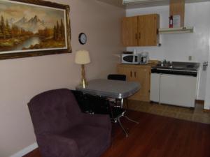 a kitchen with a table and a chair in a room at Virden Motel in Virden